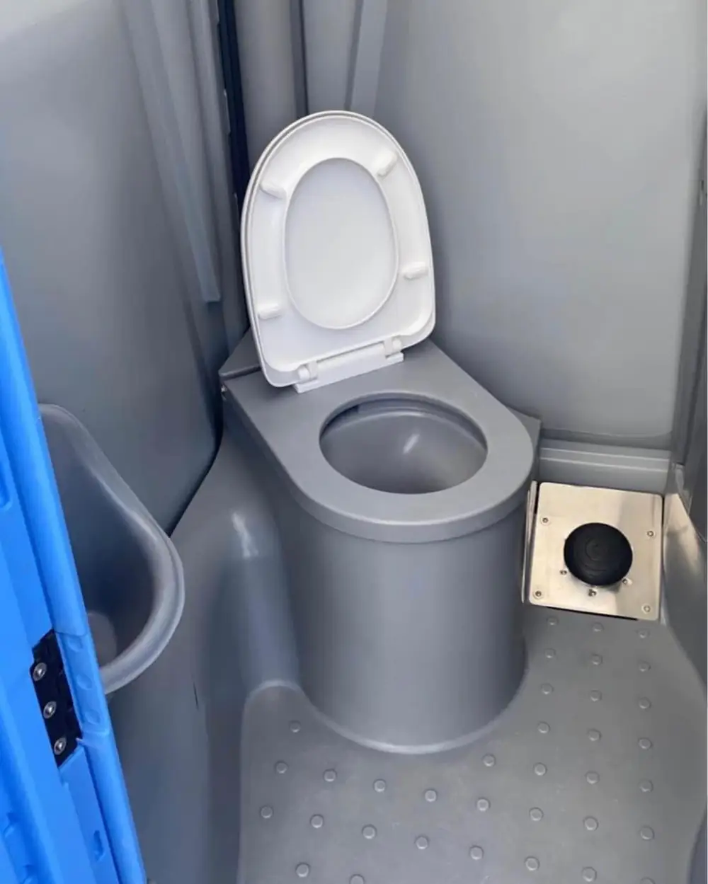 Toilet seat with lid inside a deluxe portable restroom