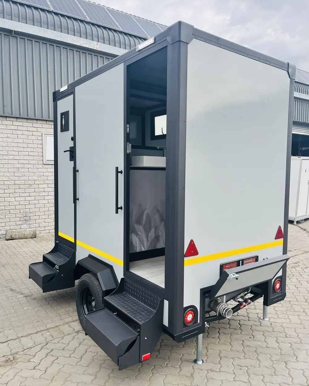 Restroom trailer with open door and steps