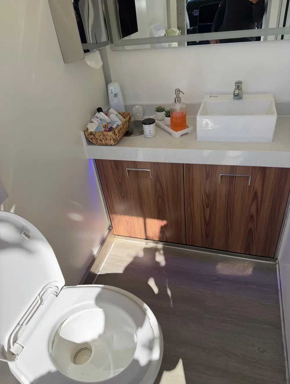 Vanity sink, mirror and soap inside a restroom trailer