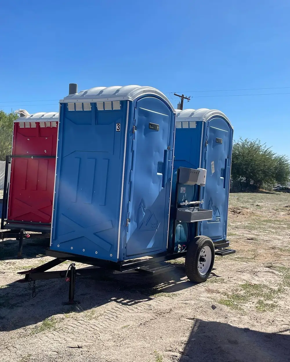 Blue porta potties ready for a construction site